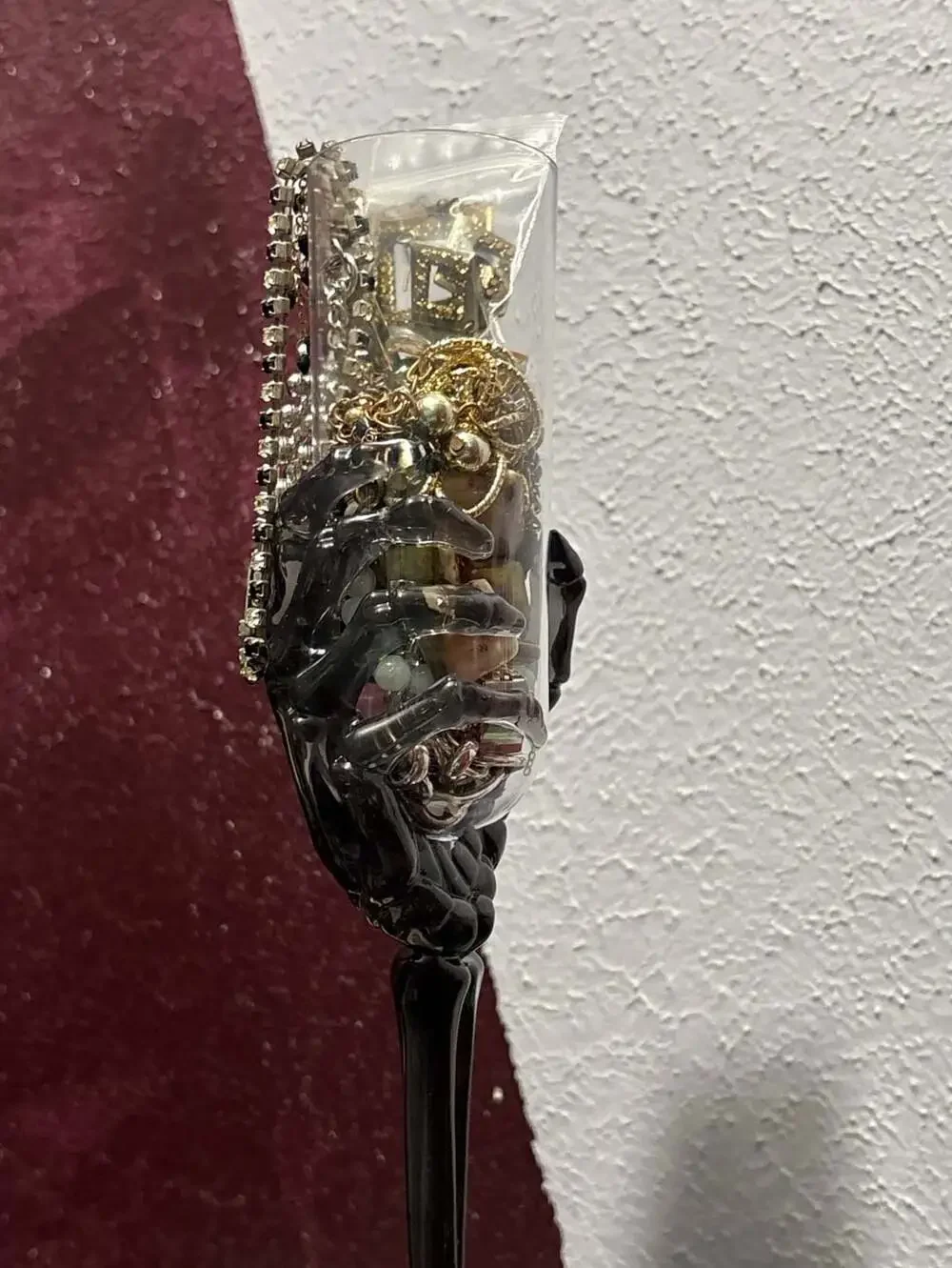 Trick or treat yourself to a skeleton hand on a flute full of jewelry